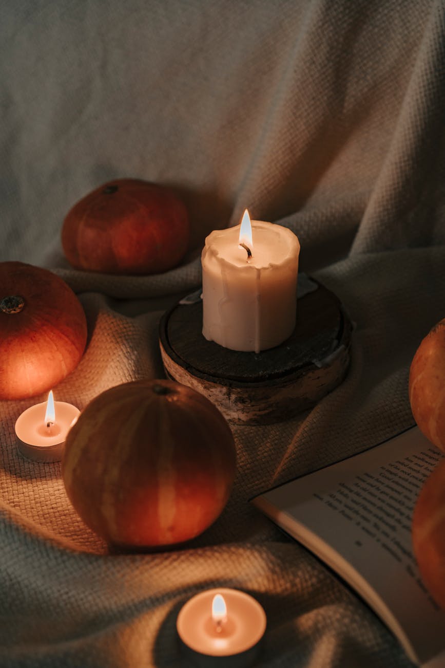 candles surrounded with pumpkins